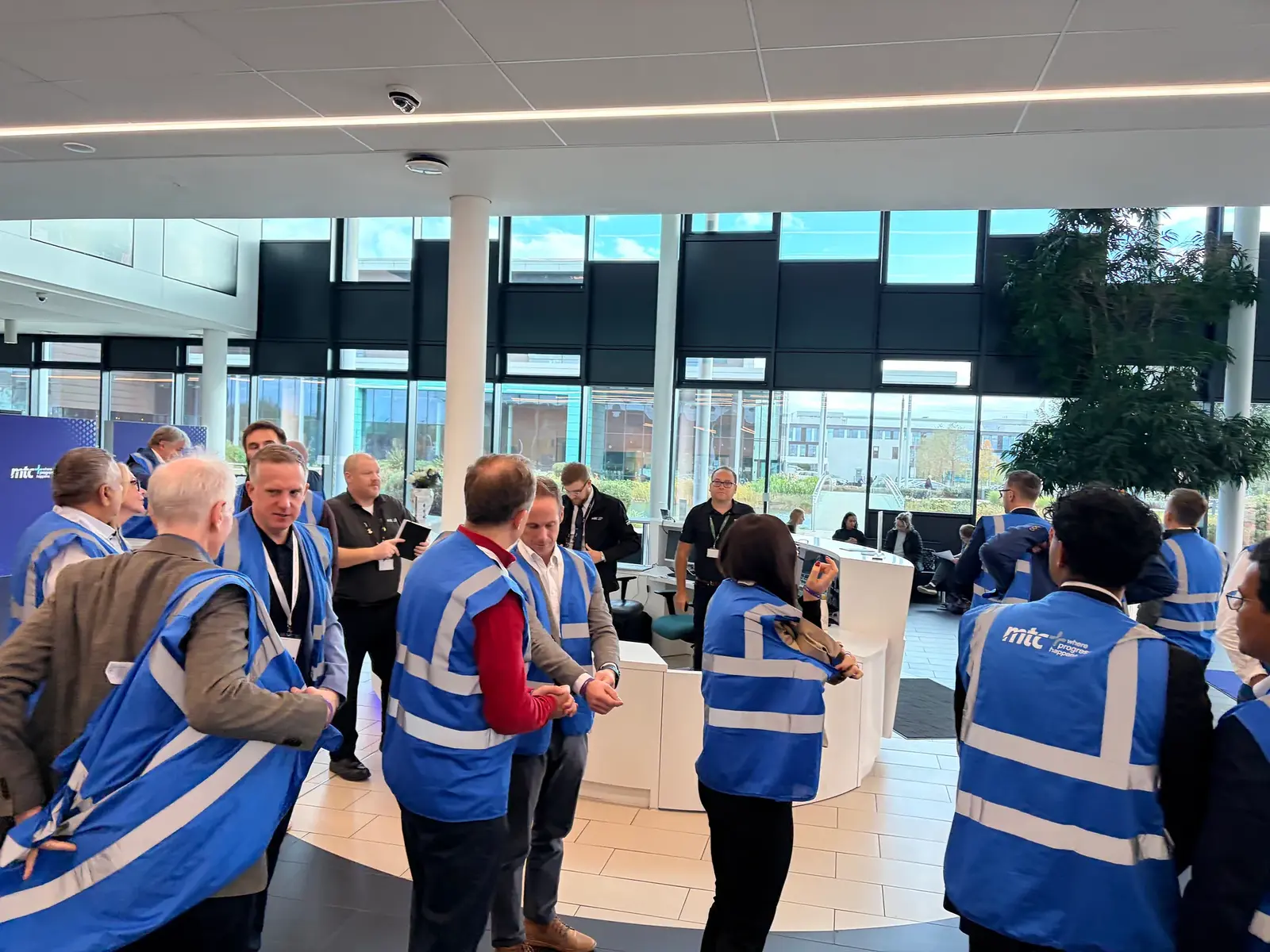 Attendees in MTC hi-vis vests gathering for the innovation lab tour